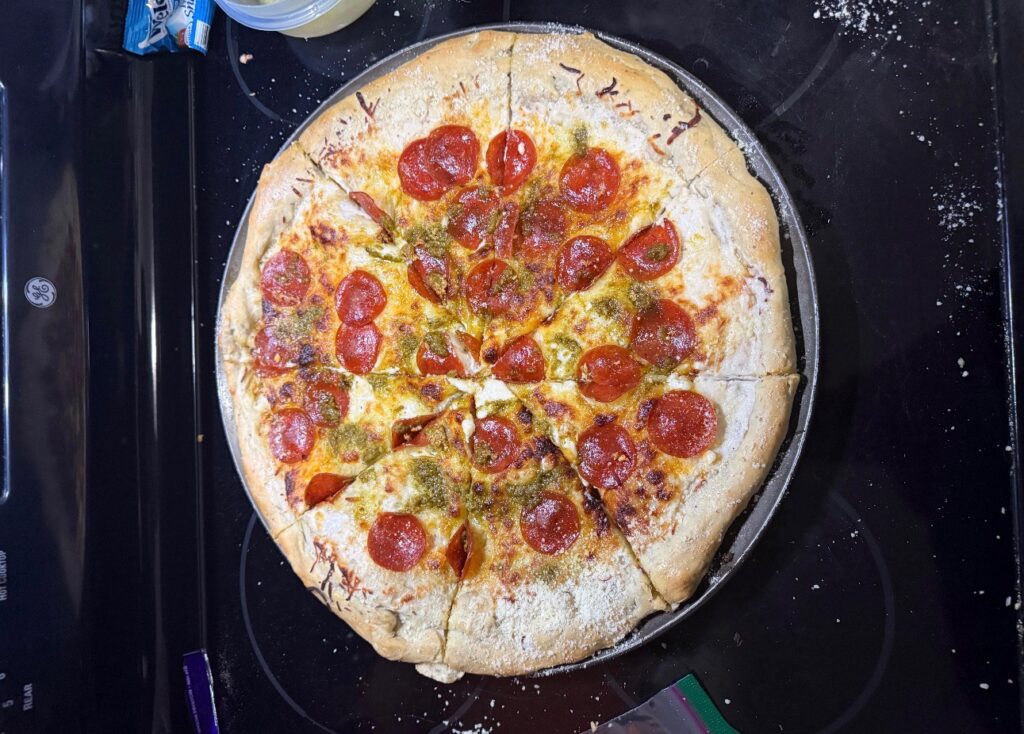 Pepperoni pan pizza on a stovetop