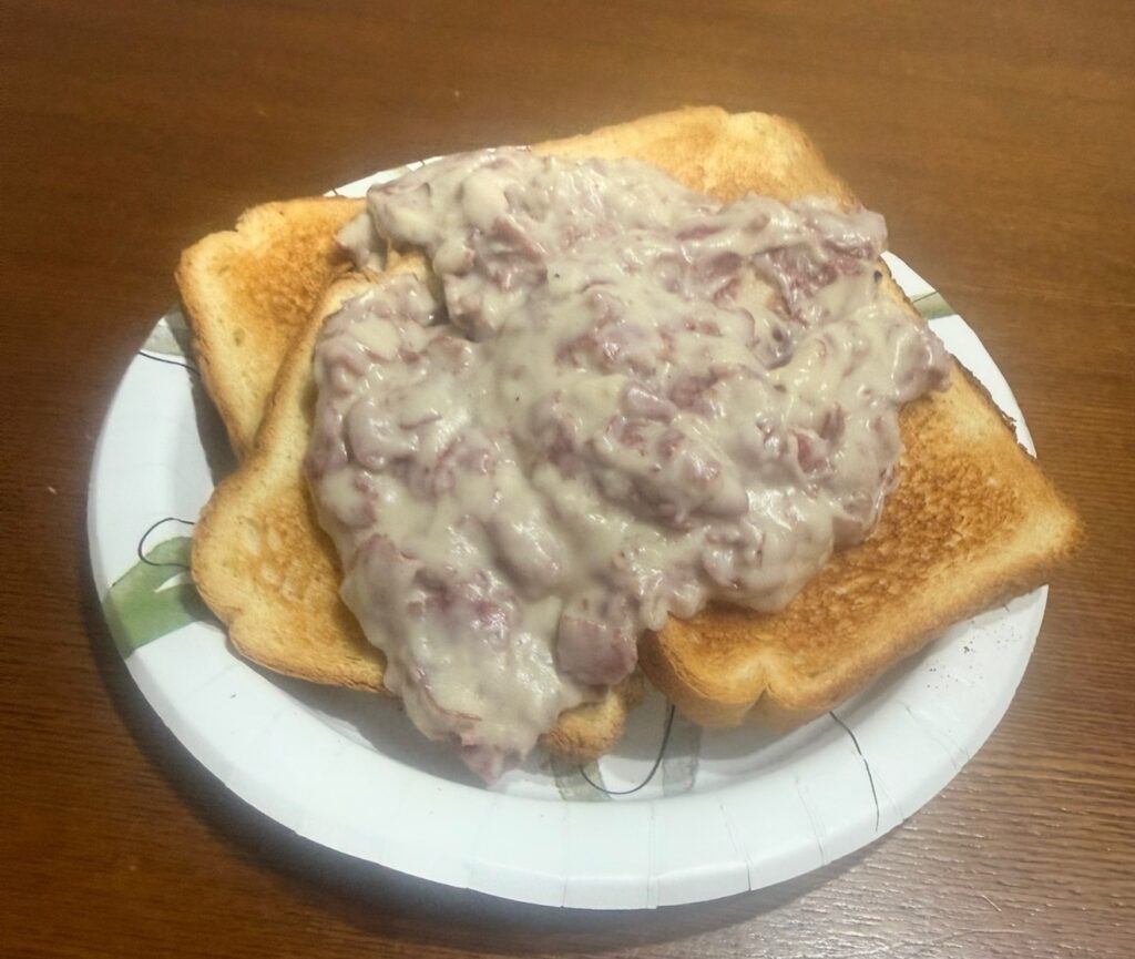 SOS gravy smothered over toast on a paper plate