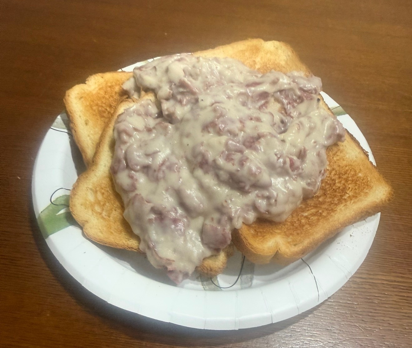 SOS gravy smothered over toast on a paper plate