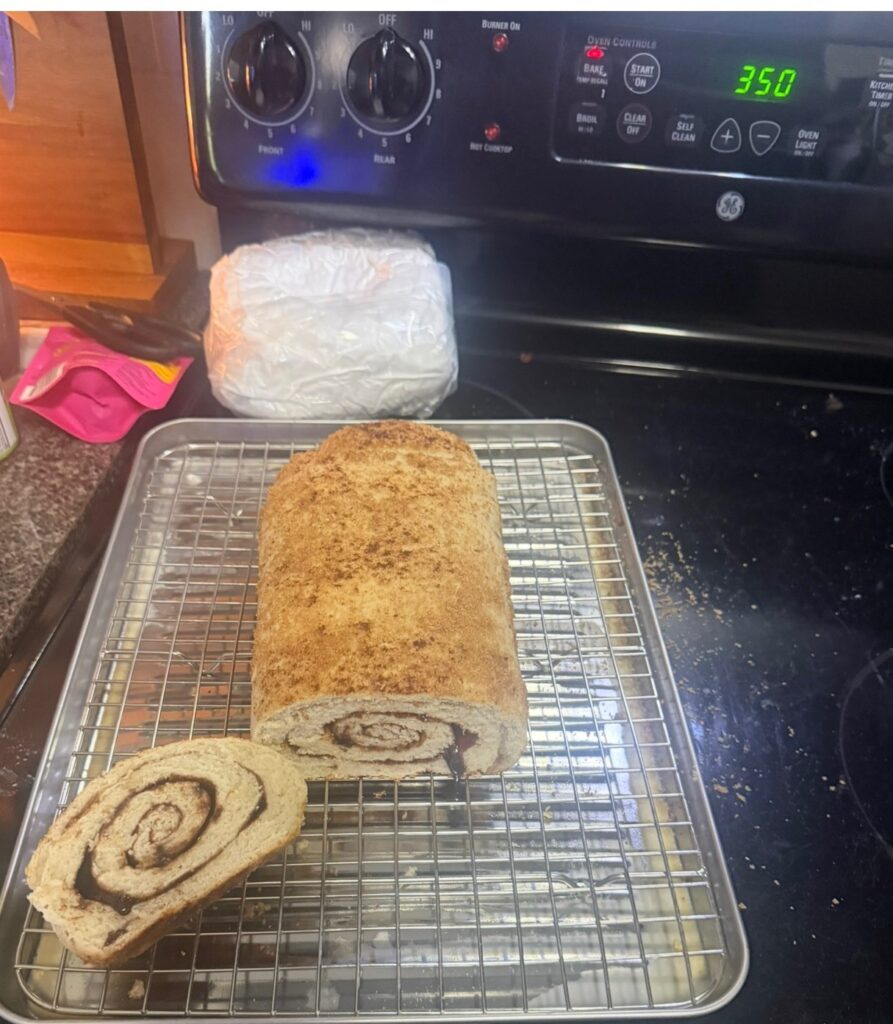 Cinnamon swirl loaf on a cooling rack in front of the stove