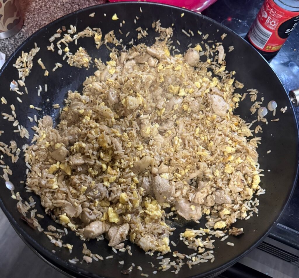 Wok full of finished chicken fried rice