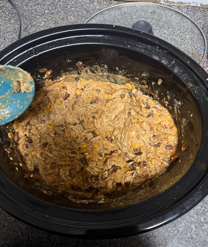 Shredded chili stirred in the crock pot